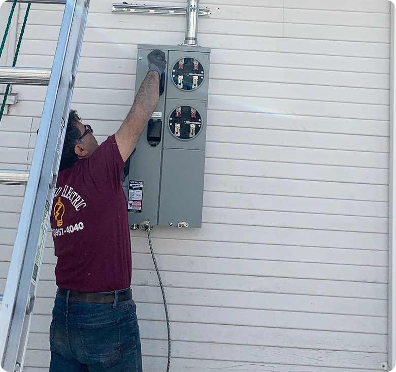 Electrician Repairing Commercial Fire Alarm System in Los Angeles Office Building